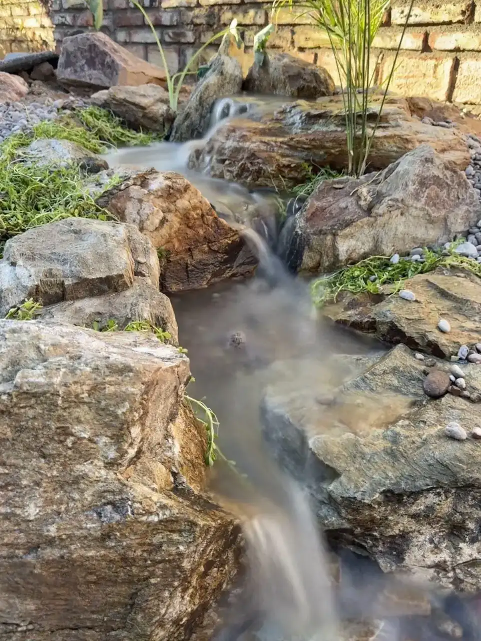 Pondless waterfall with natural stone edge in Gilbert, AZ